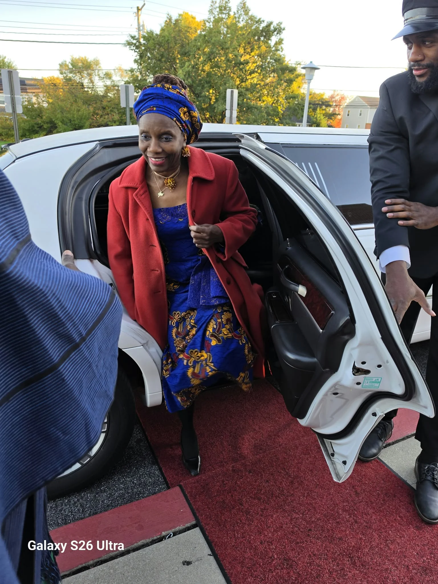 Dr. O stepping from a vehicle on arrival at the event.