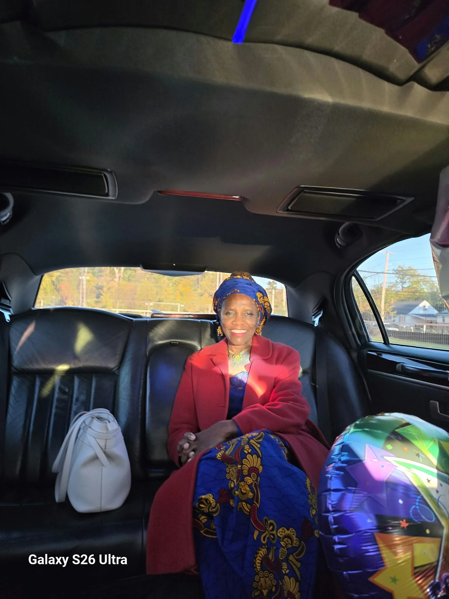 Dr. O seated in a vehicle before the celebration.